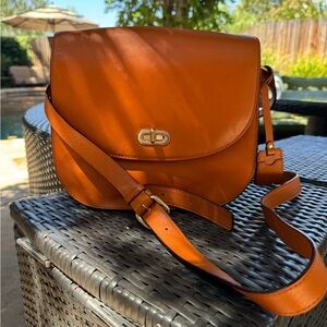 Beautiful Cognac color leather purse designed to hold an SLR camera
